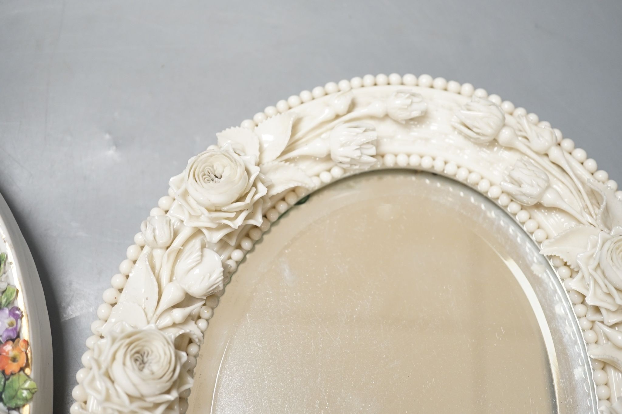 Two German porcelain easel mirrors and a Belleek easel mirror, tallest 43cm
